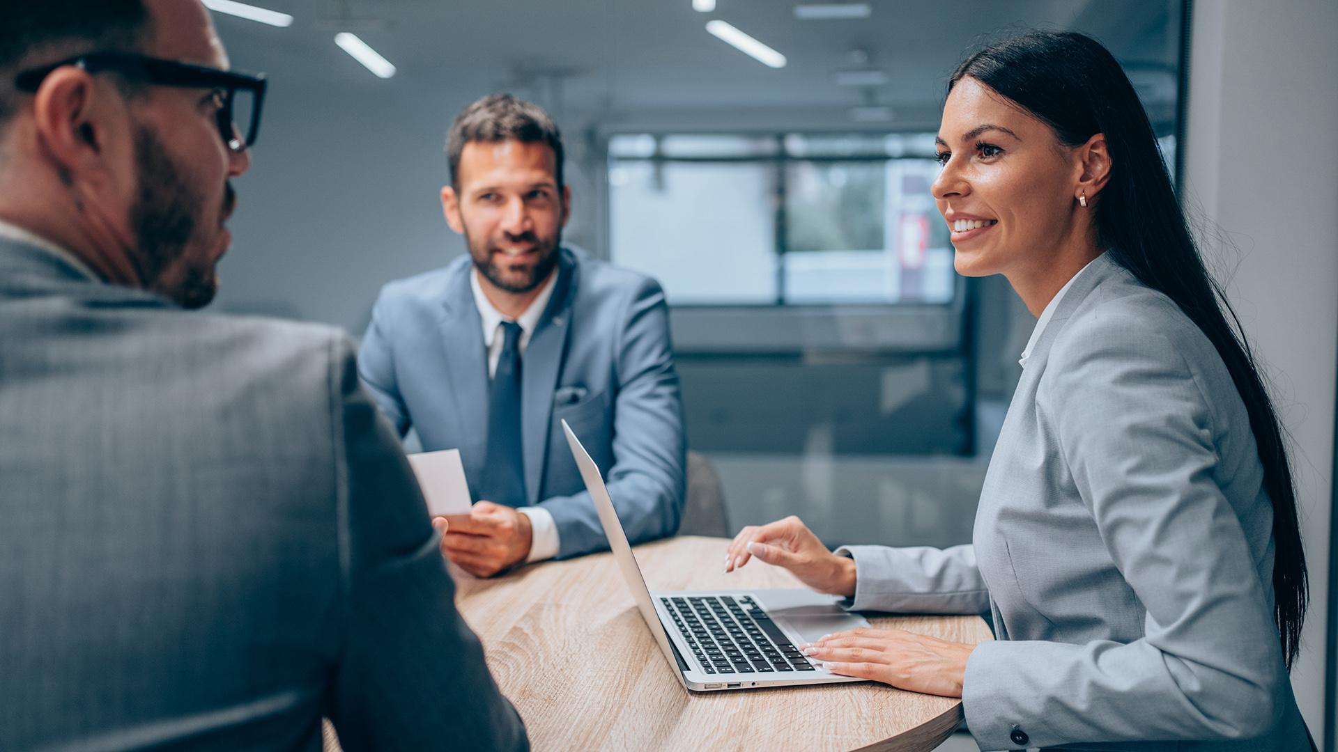 Compliance professionals reviewing trade documents in a corporate setting