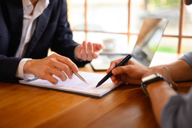 Business professionals signing trade documents and contracts